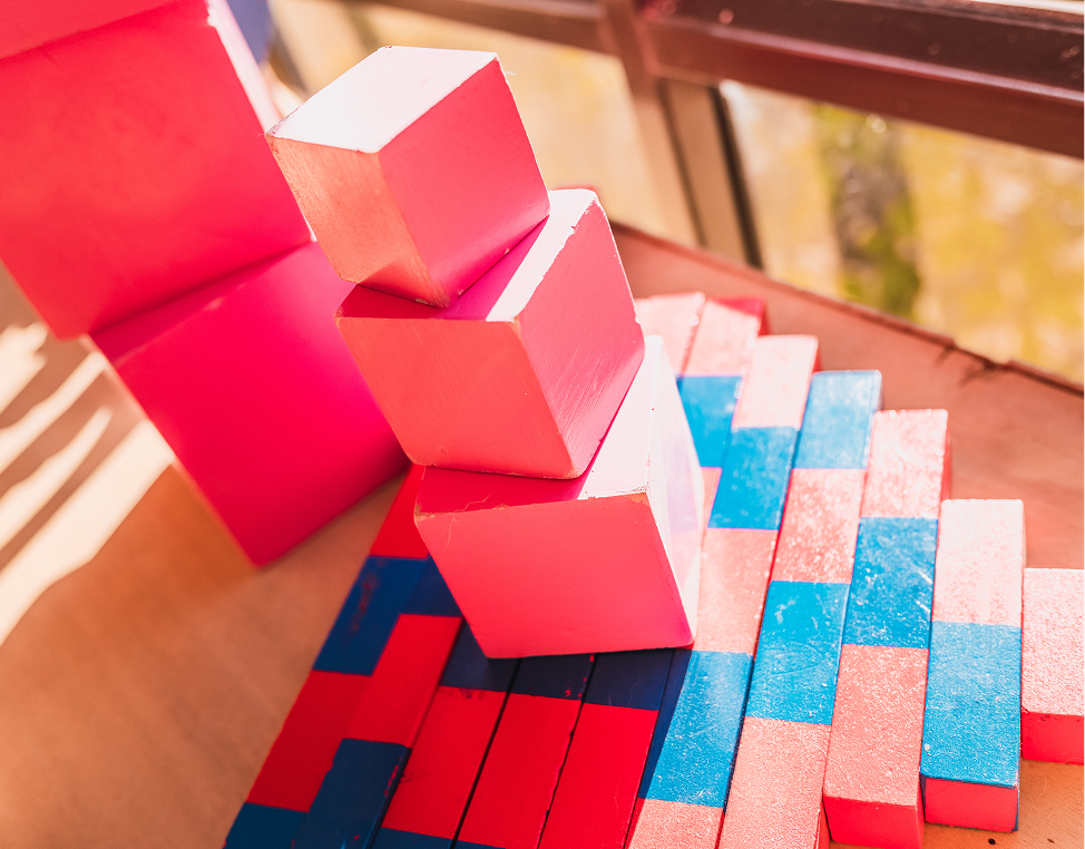 Pink and blue wooden blocks in sunlight.